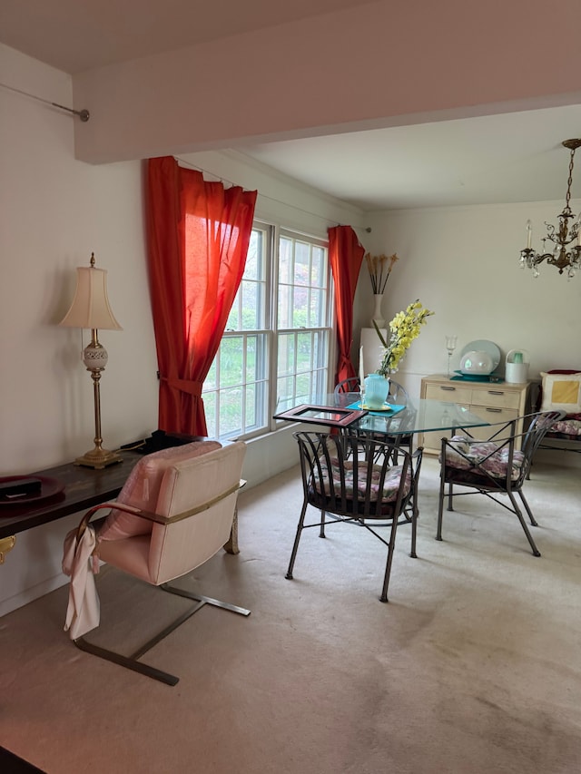 dining area with carpet floors and a chandelier