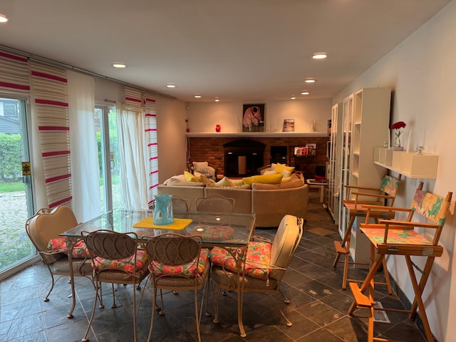 dining area featuring recessed lighting and a brick fireplace