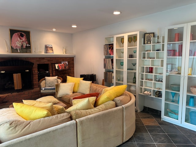 living room featuring a brick fireplace and recessed lighting