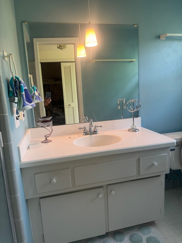 bathroom with vanity, toilet, and tile patterned flooring