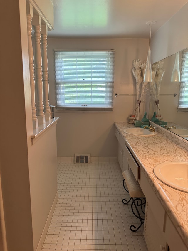 bathroom featuring tile patterned flooring and double vanity