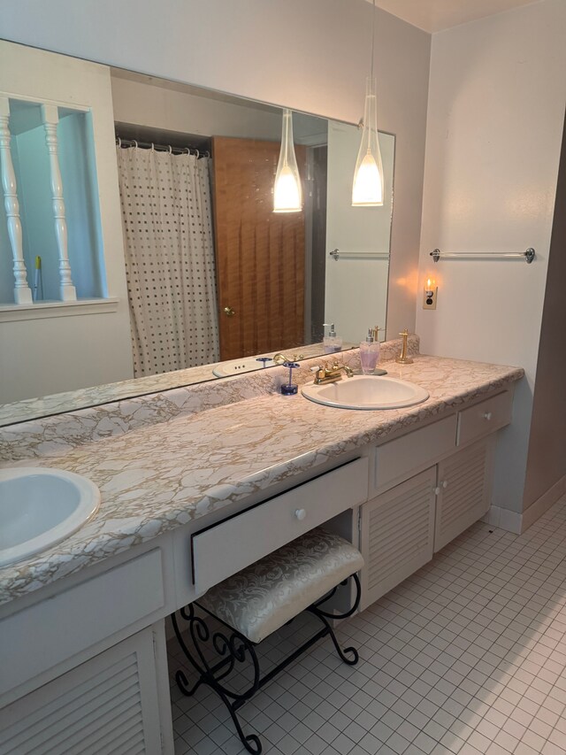 bathroom with tile patterned floors and vanity
