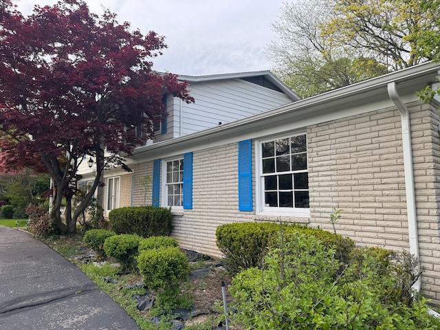view of property exterior with brick siding