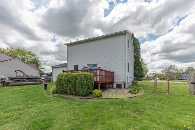 rear view of property with a wooden deck and central AC unit
