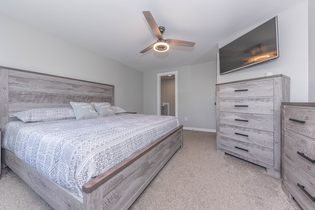 bedroom with light carpet, baseboards, and a ceiling fan
