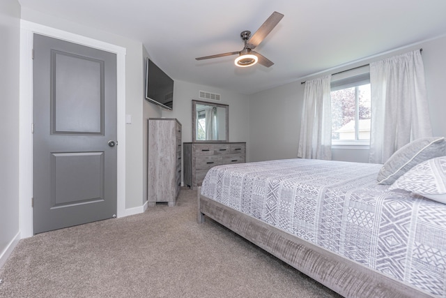 carpeted bedroom featuring baseboards and ceiling fan