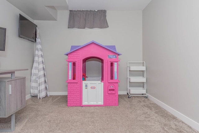 recreation room with carpet floors and baseboards