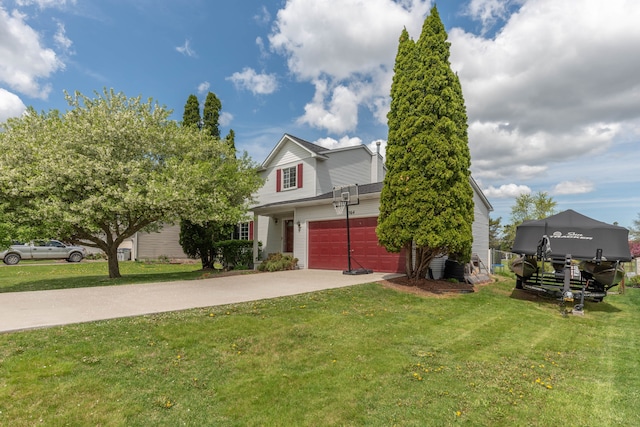 view of front of house with concrete driveway and a front lawn
