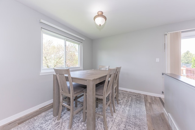 dining room featuring light wood-style floors and baseboards