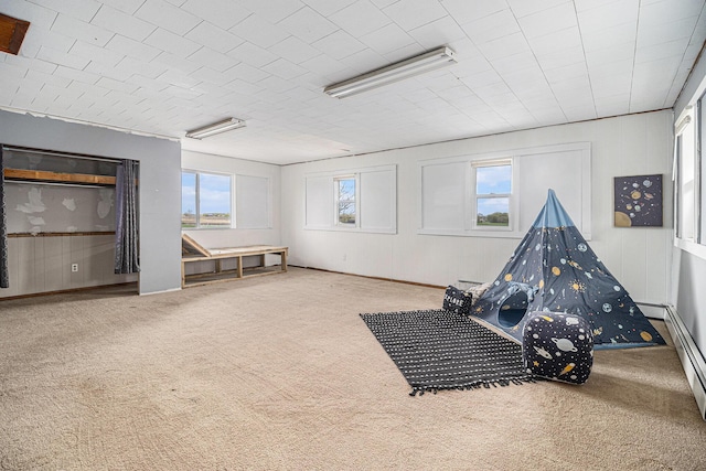 recreation room with carpet floors and plenty of natural light