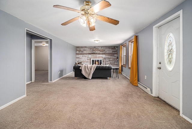 bedroom with light carpet, baseboard heating, a fireplace, and baseboards