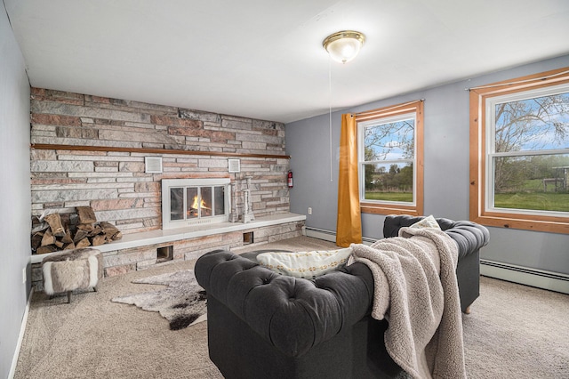 living area with carpet floors, a stone fireplace, and a baseboard radiator