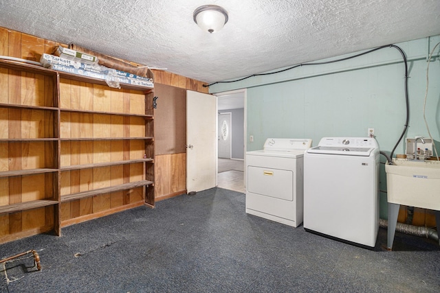 laundry area featuring washing machine and dryer and a textured ceiling