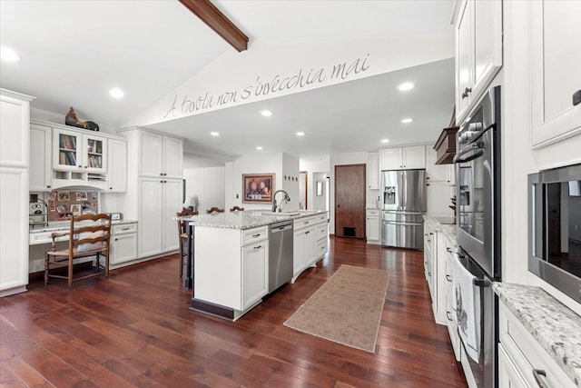 kitchen featuring stainless steel appliances, beamed ceiling, white cabinets, dark wood finished floors, and high vaulted ceiling