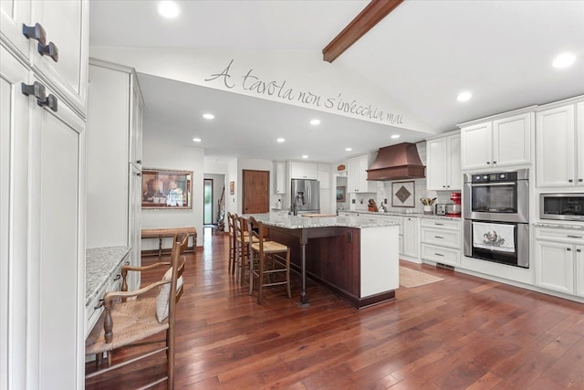 kitchen featuring premium range hood, appliances with stainless steel finishes, dark wood-type flooring, white cabinets, and recessed lighting