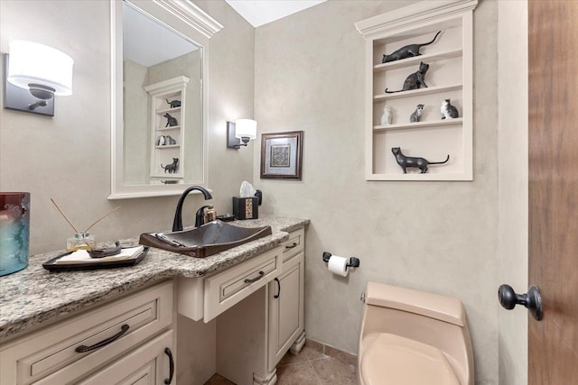 bathroom featuring toilet, vanity, and tile patterned floors
