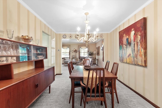 carpeted dining area with a chandelier, ornamental molding, wallpapered walls, and baseboards