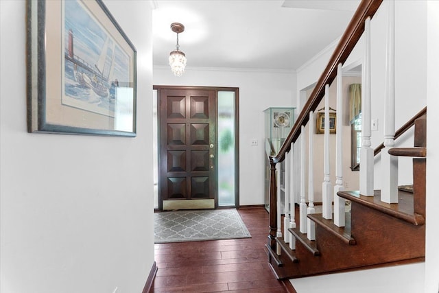 entrance foyer with dark wood-style flooring, stairway, crown molding, and baseboards