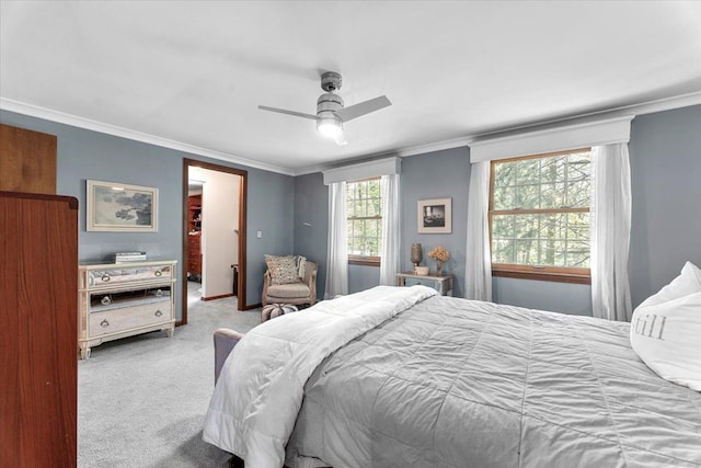 bedroom with carpet flooring, crown molding, and ceiling fan