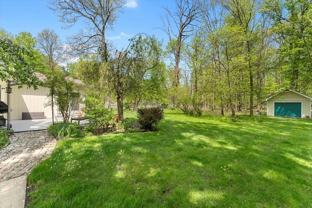 view of green lawn featuring an outbuilding