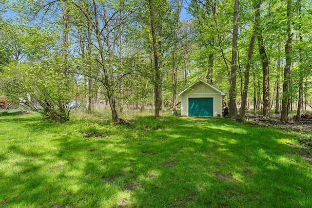 view of green lawn with an outbuilding