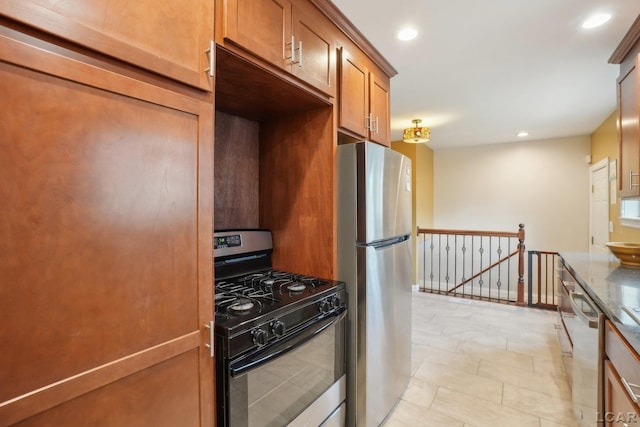 2905 Marshall St, Ann Arbor, MI 48108 - kitchen with stainless steel appliances, brown cabinetry, recessed lighting, and stone countertops