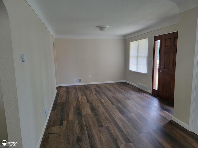 442 Beach St, Mount Morris, MI 48458 - entrance foyer with dark wood-style floors, baseboards, and arched walkways