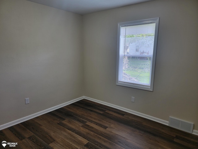 442 Beach St, Mount Morris, MI 48458 - unfurnished room with baseboards and dark wood-style flooring