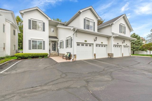 1704 Cassady Place Dr, Plymouth, MI 48170 - traditional-style house featuring a garage, entry steps, and asphalt driveway