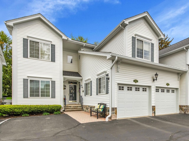 1704 Cassady Place Dr, Plymouth, MI 48170 - traditional-style house with asphalt driveway, a garage, and stone siding