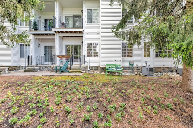 1704 Cassady Place Dr, Plymouth, MI 48170 - rear view of property featuring a balcony, central AC unit, and a patio