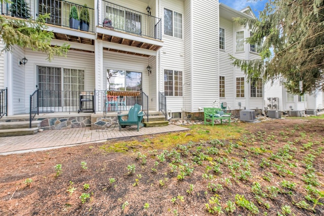1704 Cassady Place Dr, Plymouth, MI 48170 - back of property with a balcony, central AC, and a porch