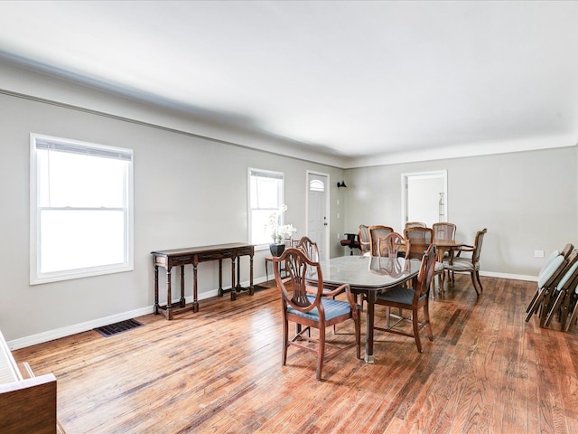 dining space with wood finished floors and baseboards