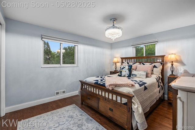 207 Old Perch Rd, Rochester Hills, MI 48309 - bedroom with baseboards, wood finished floors, and a chandelier