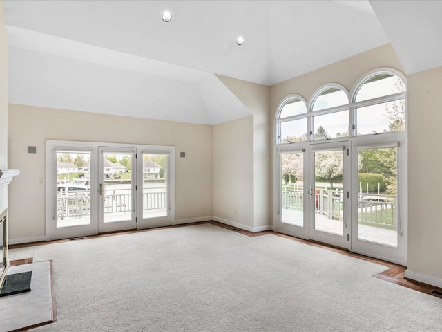 3744 Riverview Ter N, East China, MI 48054 - unfurnished living room with a glass covered fireplace, high vaulted ceiling, baseboards, and carpet floors