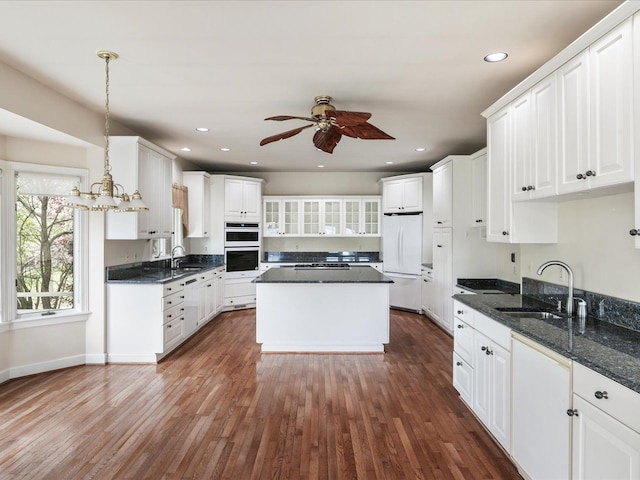 3744 Riverview Ter N, East China, MI 48054 - kitchen with white appliances, a sink, ceiling fan, white cabinets, and recessed lighting