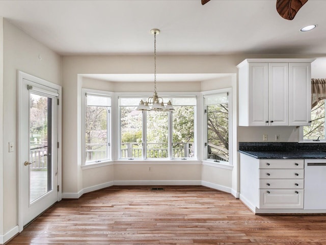 3744 Riverview Ter N, East China, MI 48054 - kitchen with baseboards, light wood-type flooring, dark countertops, white cabinetry, and recessed lighting