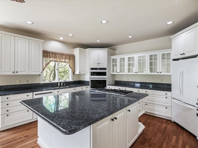3744 Riverview Ter N, East China, MI 48054 - kitchen with white appliances, a sink, white cabinetry, a kitchen island, and glass insert cabinets