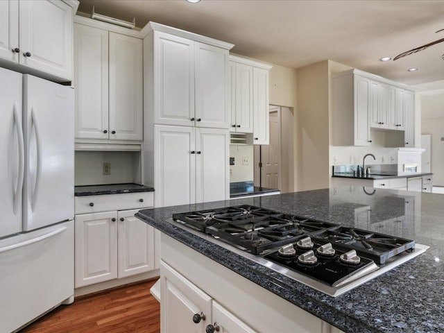 3744 Riverview Ter N, East China, MI 48054 - kitchen with freestanding refrigerator, black gas stovetop, white cabinetry, recessed lighting, and dark stone countertops