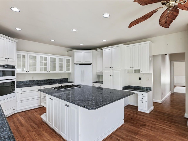 3744 Riverview Ter N, East China, MI 48054 - kitchen with freestanding refrigerator, stainless steel gas stovetop, dark wood finished floors, glass insert cabinets, and recessed lighting