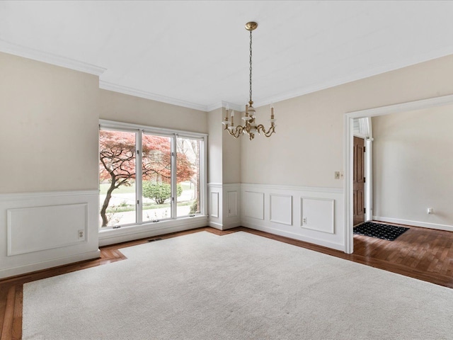 3744 Riverview Ter N, East China, MI 48054 - unfurnished dining area featuring a chandelier, wood finished floors, crown molding, and wainscoting