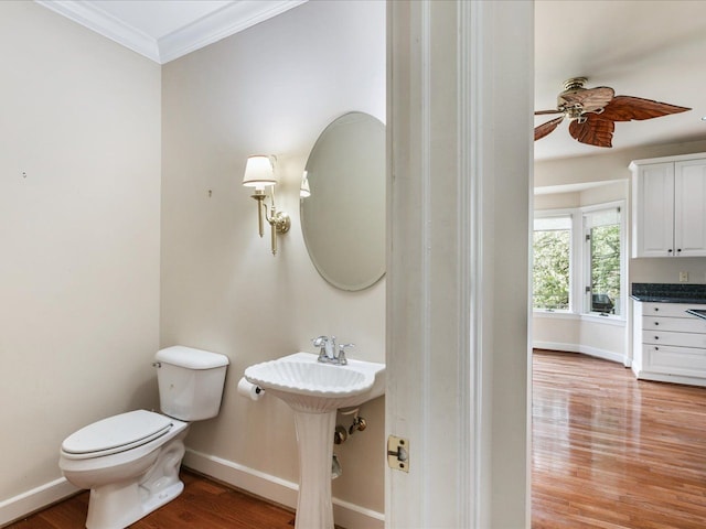 3744 Riverview Ter N, East China, MI 48054 - bathroom featuring toilet, baseboards, wood finished floors, ornamental molding, and a ceiling fan