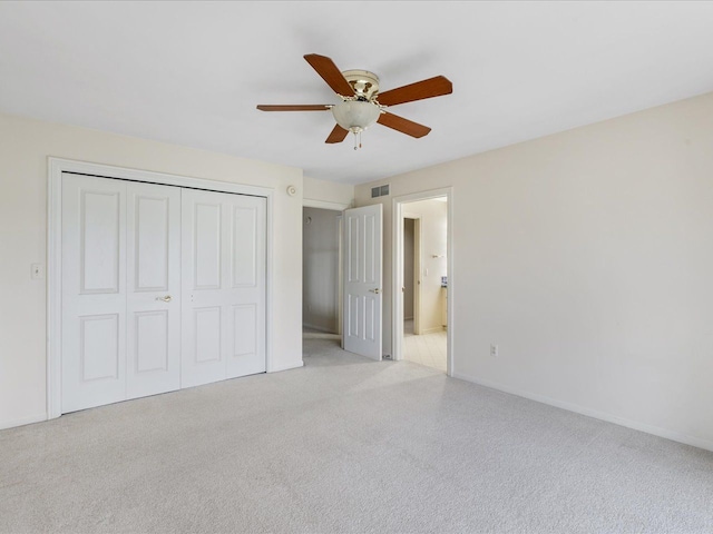 3744 Riverview Ter N, East China, MI 48054 - unfurnished bedroom with a closet, baseboards, carpet floors, ceiling fan, and connected bathroom