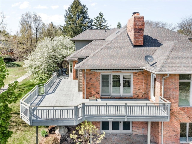 3744 Riverview Ter N, East China, MI 48054 - back of property with a shingled roof, a chimney, brick siding, and a wooden deck