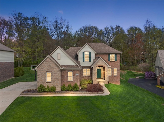 5633 Golf Pointe Dr, Clarkston, MI 48348 - traditional-style home with brick siding, a front lawn, and driveway