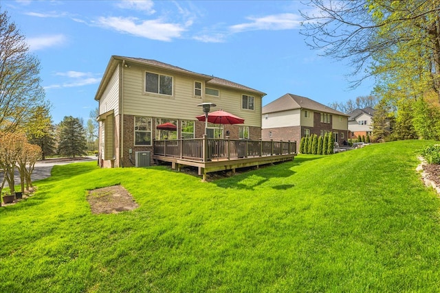 5633 Golf Pointe Dr, Clarkston, MI 48348 - back of house featuring brick siding, a lawn, a deck, and central AC