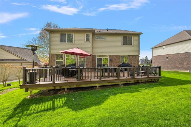 5633 Golf Pointe Dr, Clarkston, MI 48348 - back of house with brick siding, a deck, and a lawn