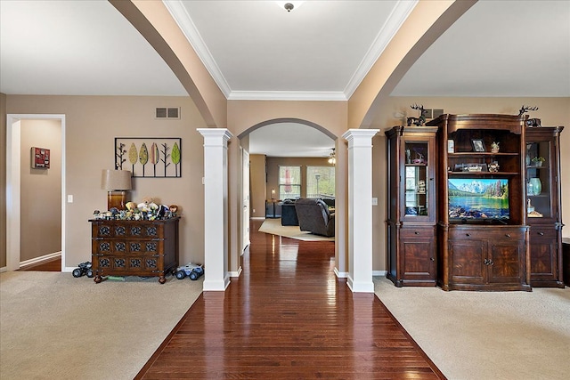 5633 Golf Pointe Dr, Clarkston, MI 48348 - entrance foyer featuring ornate columns, arched walkways, crown molding, baseboards, and wood finished floors