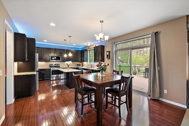 5633 Golf Pointe Dr, Clarkston, MI 48348 - dining space with dark wood-type flooring, a chandelier, baseboards, and recessed lighting