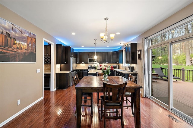 5633 Golf Pointe Dr, Clarkston, MI 48348 - dining space featuring dark wood-style flooring, a chandelier, baseboards, and recessed lighting